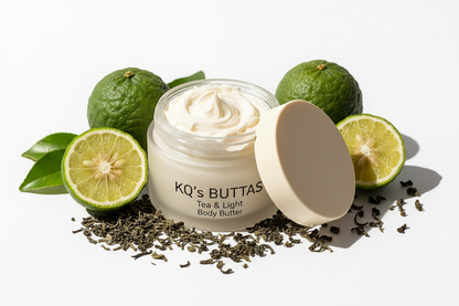 KQ's BUTTAs 4oz Tea & Light body butter in an open cosmetic jar surrounded by bergamot and tea leaves 