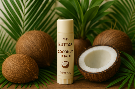 KQ's BUTTAs coconut lip balm surrounded by random coconuts and coconut plants