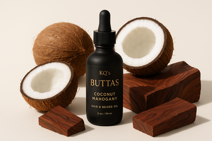 KQ's BUTTAs Coconut Mahogany Hair & Beard Oil 2oz in a black bottle surrounds by coconuts and Mahogany in a light background