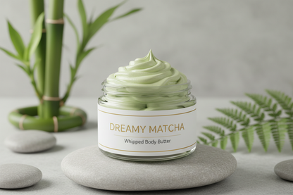 KQ's BUTTAs Dreamy Matcha body Butta 4 oz open clear cosmetic jar in a tranquil setting