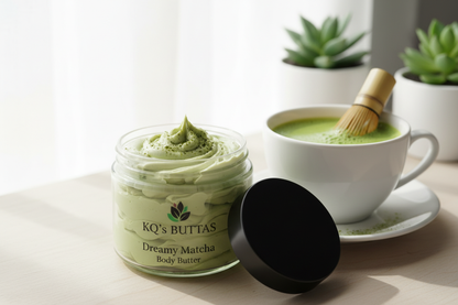 KQ's BUTTAs Dreamy Matcha body butter 4oz open jar bright background with a cup of matcha